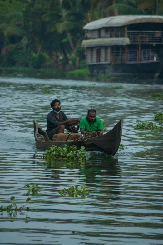 two people on a small canoe in the water