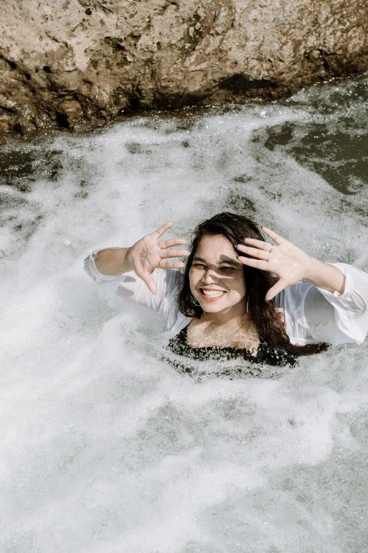 a woman is floating in a body of water