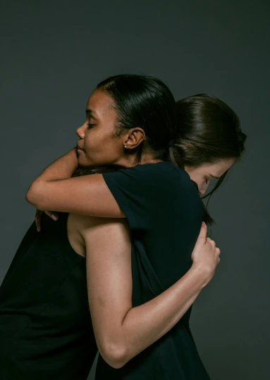 two women hug as they are in the same position