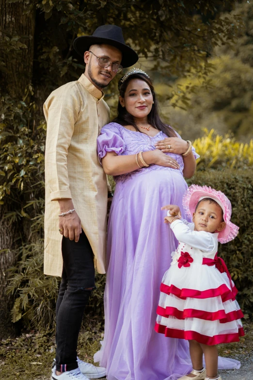 a family posing for a po in a park