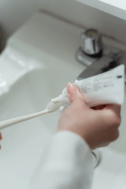 someone using their toothbrush to clean their teeth