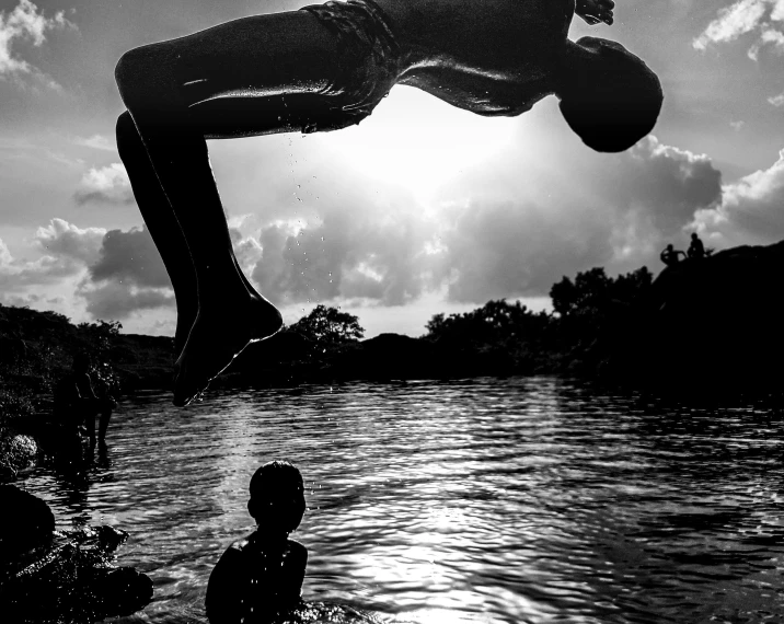 the boy is watching his friend in the water