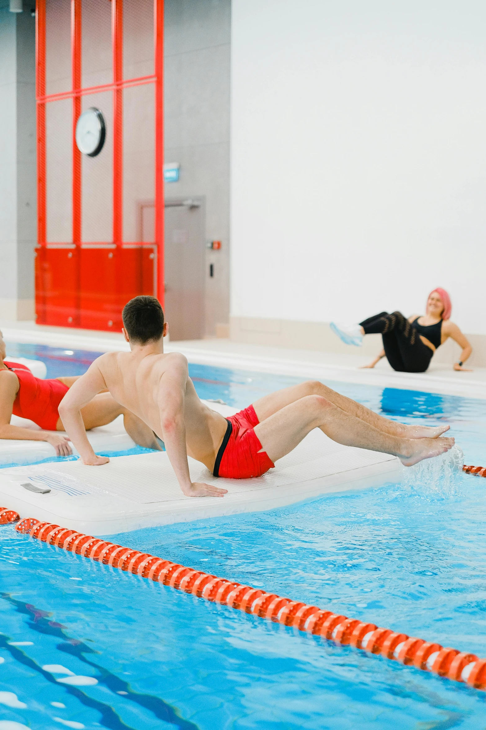 two people are exercising in a swimming pool