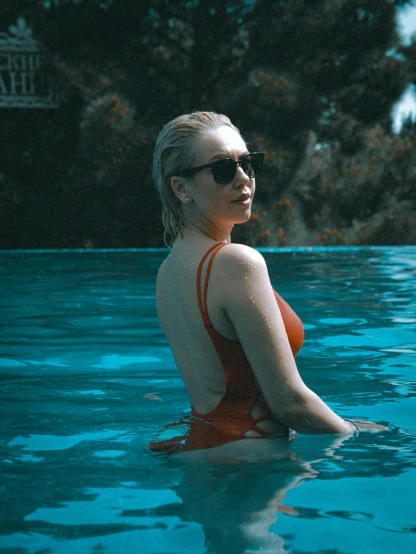 a woman in a red bikini sitting in a pool