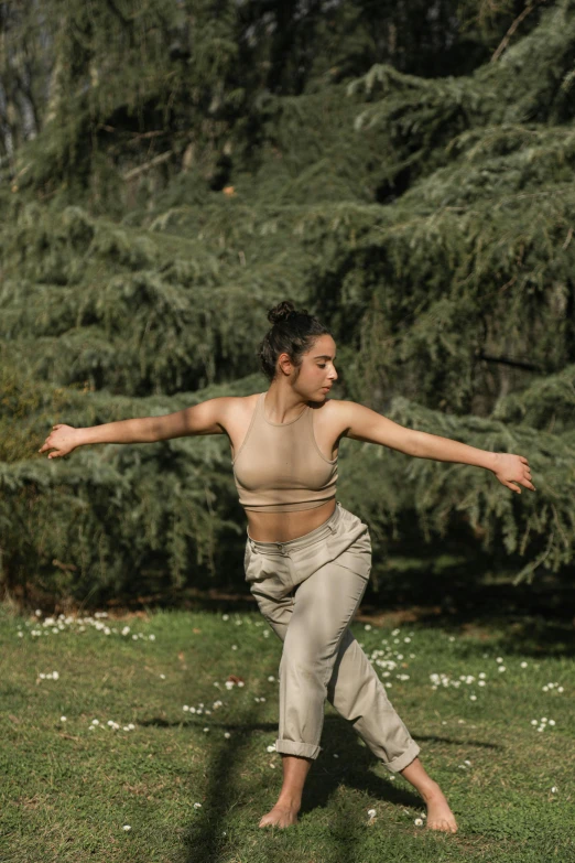 a woman in a tank top stretching her arms in the air