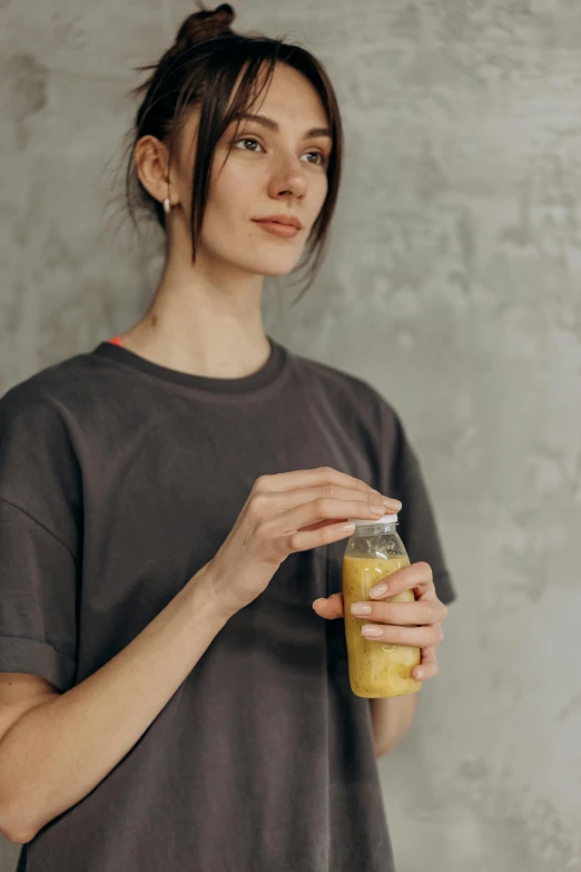 woman holding jar full of food sitting on floor