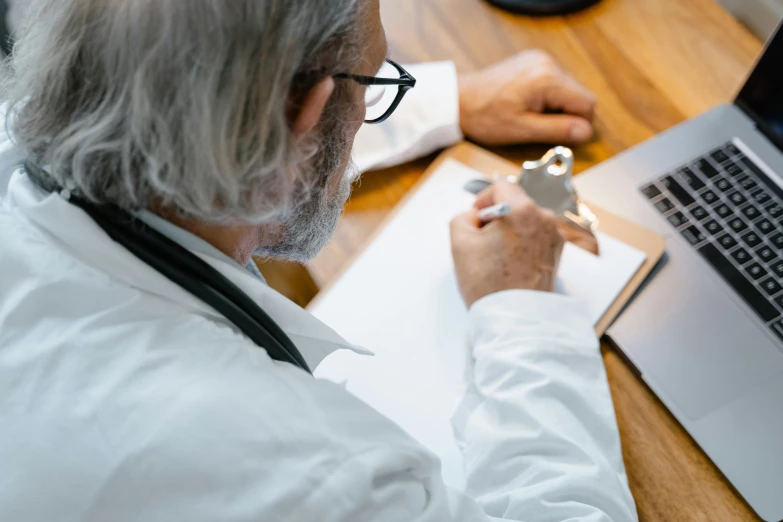 a man with glasses working on a computer