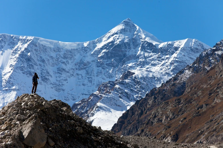 two people standing on top of a snowy mountain