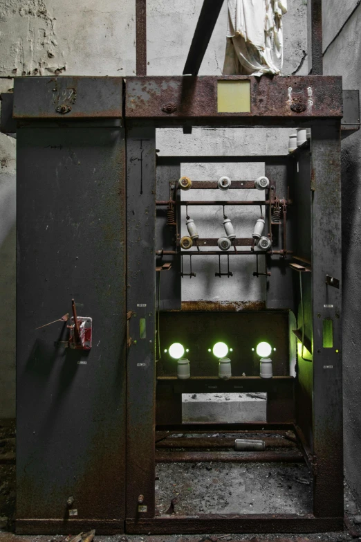 a large metal furnace in a large room with green lighting