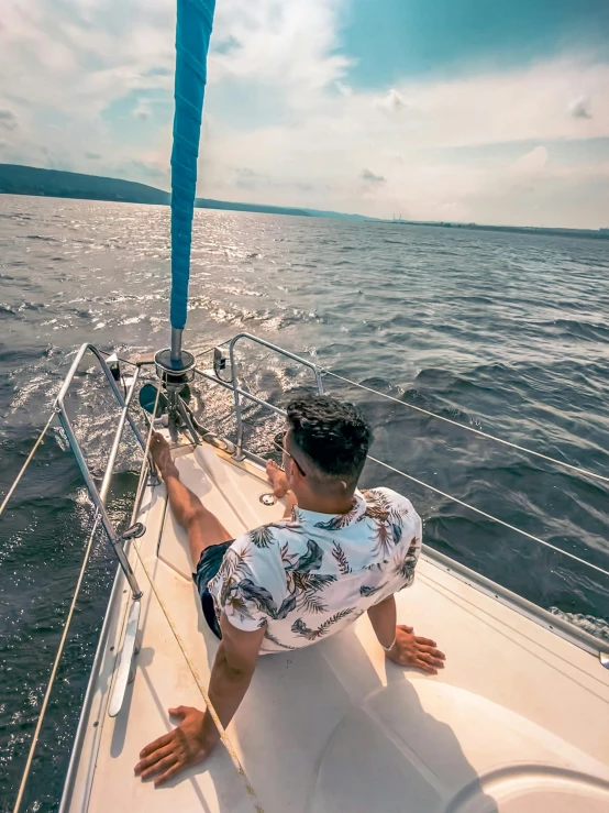 a boy is riding on a sail boat