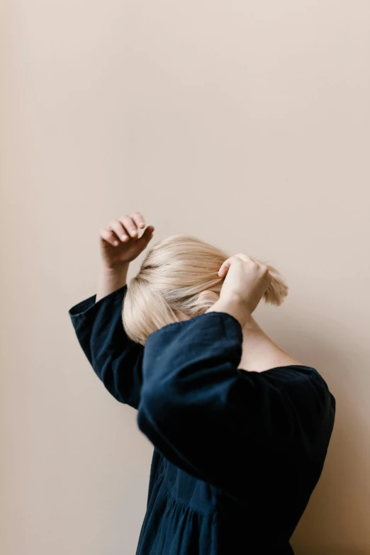 a woman combing her hair with a brush