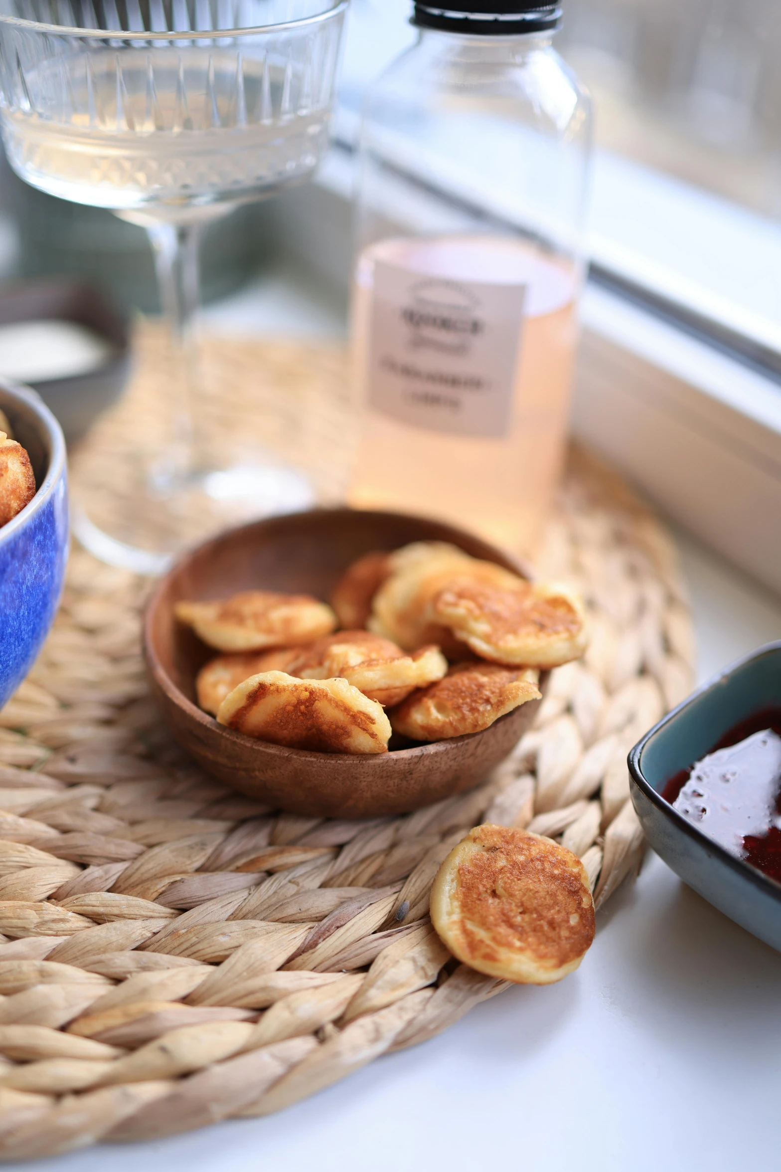 a bowl full of cinnamon sugar on top of a woven place mat