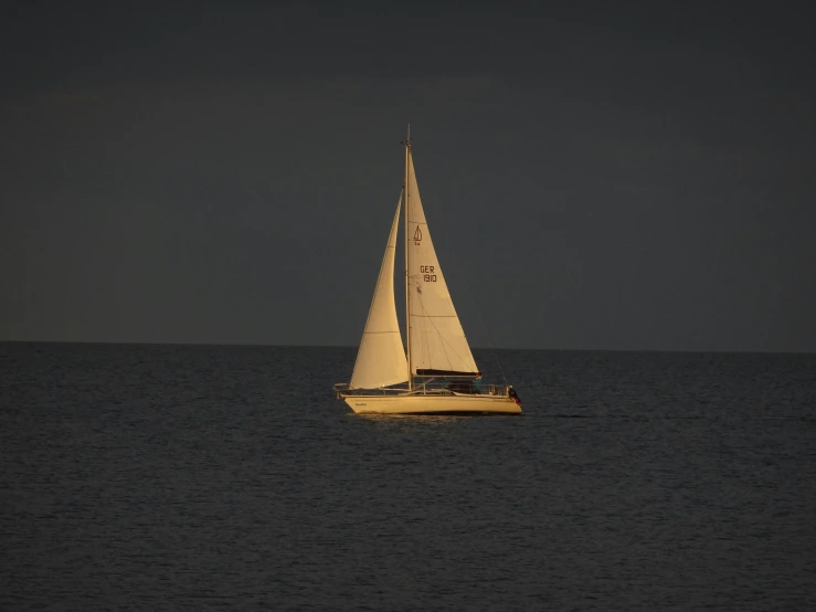 a sail boat sailing across a large body of water