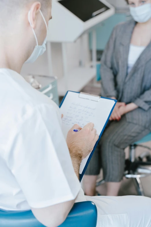 a nurse in the office writing down a note