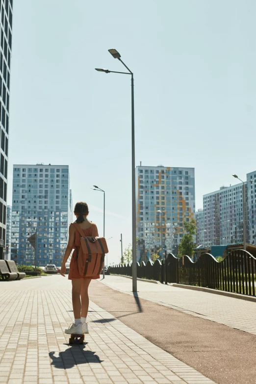 a woman riding a skateboard down the street