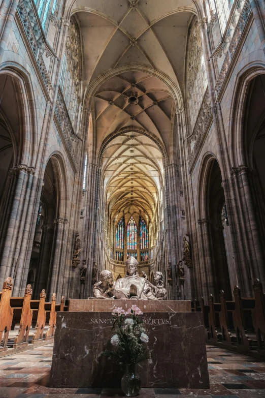 an interior view of a cathedral that has statues on it