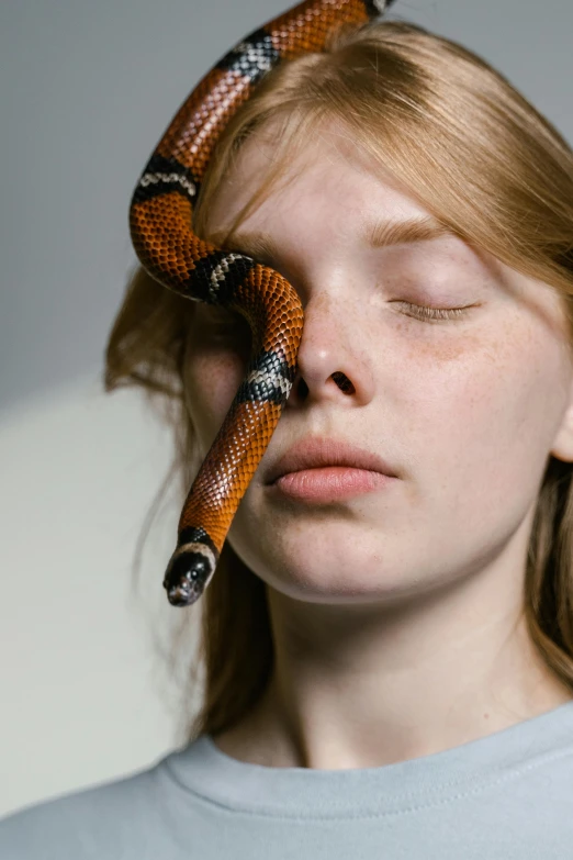 a woman is holding an animal shaped object to her face