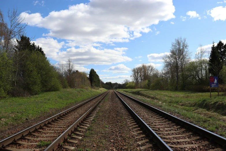 a road train track that is going through some grass