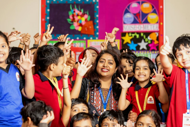 a group of children holding up hands