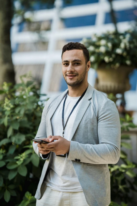 a man looking at his cell phone and smiling