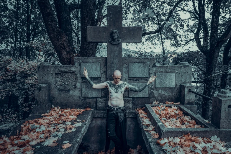a man with his hands up in chains next to a grave