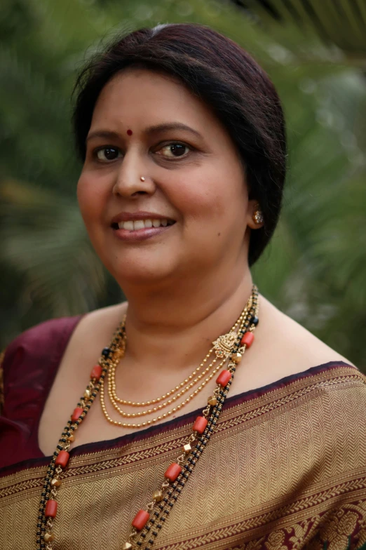 a beautiful woman wearing an ethnic necklace and celet