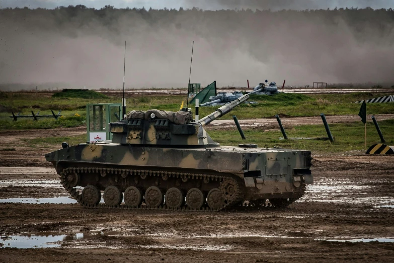 an army tank sitting on top of a muddy field