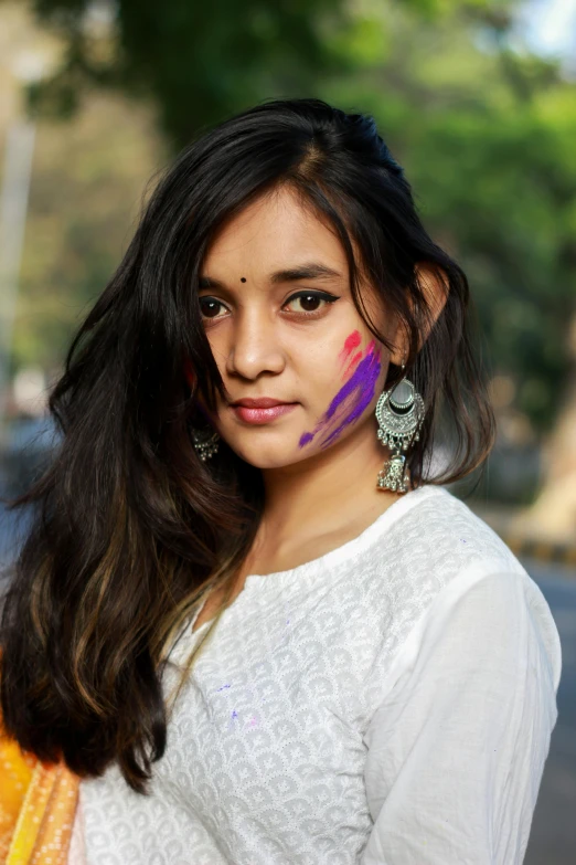 a woman has painted her face on the street