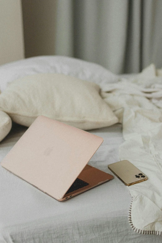 a notebook, money and a notepad laying on a bed