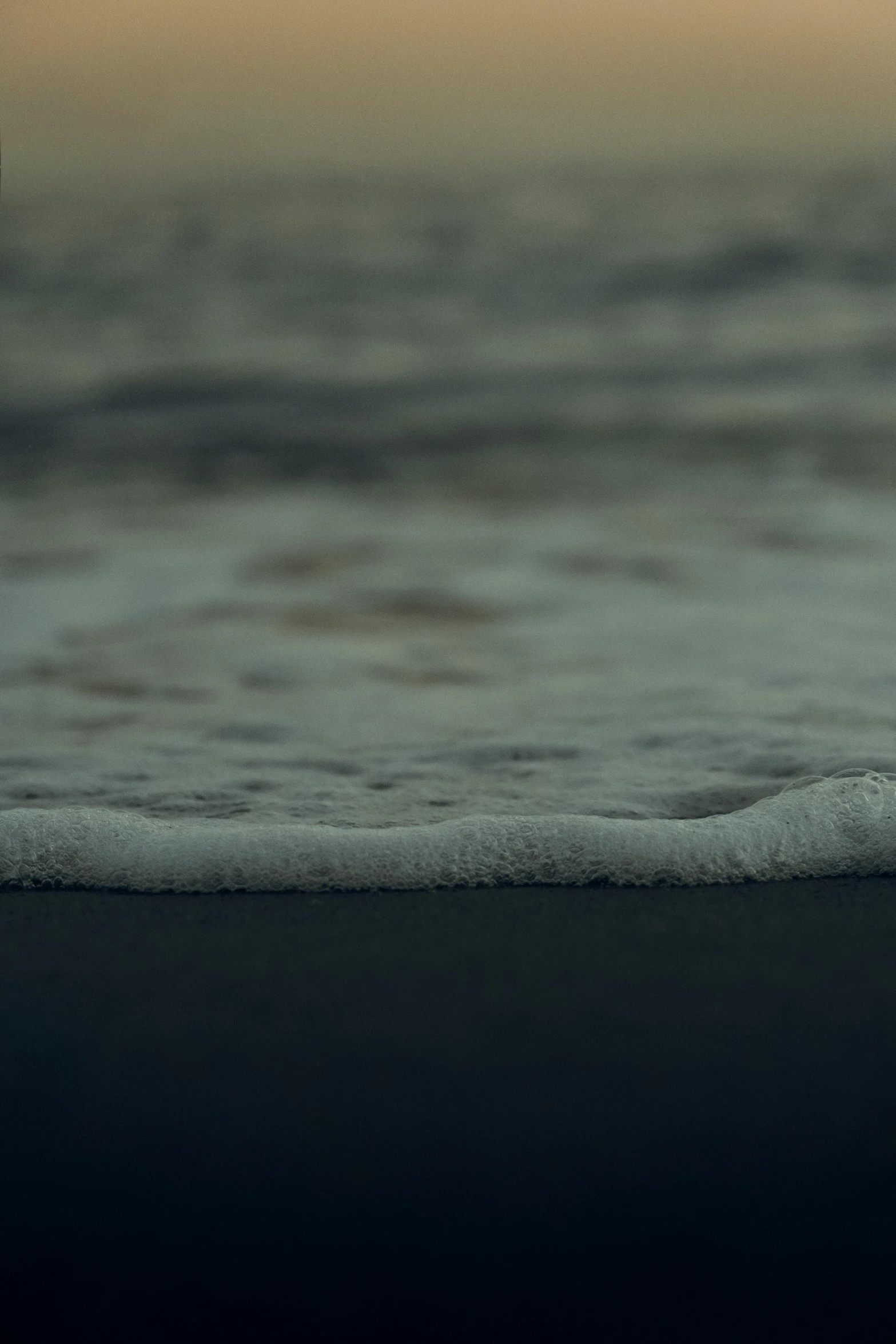 a man carrying a surfboard into the ocean