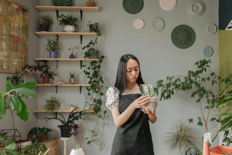 a woman standing by a desk looking at soing