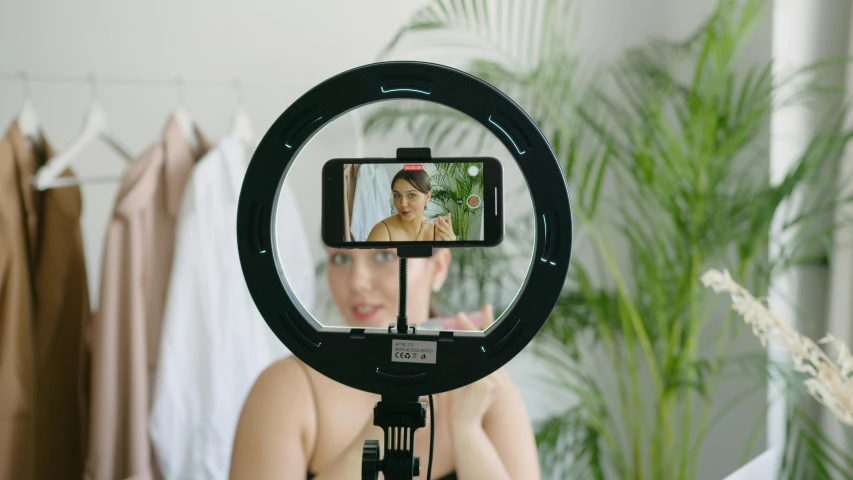 a female getting her po taken with an electric mirror