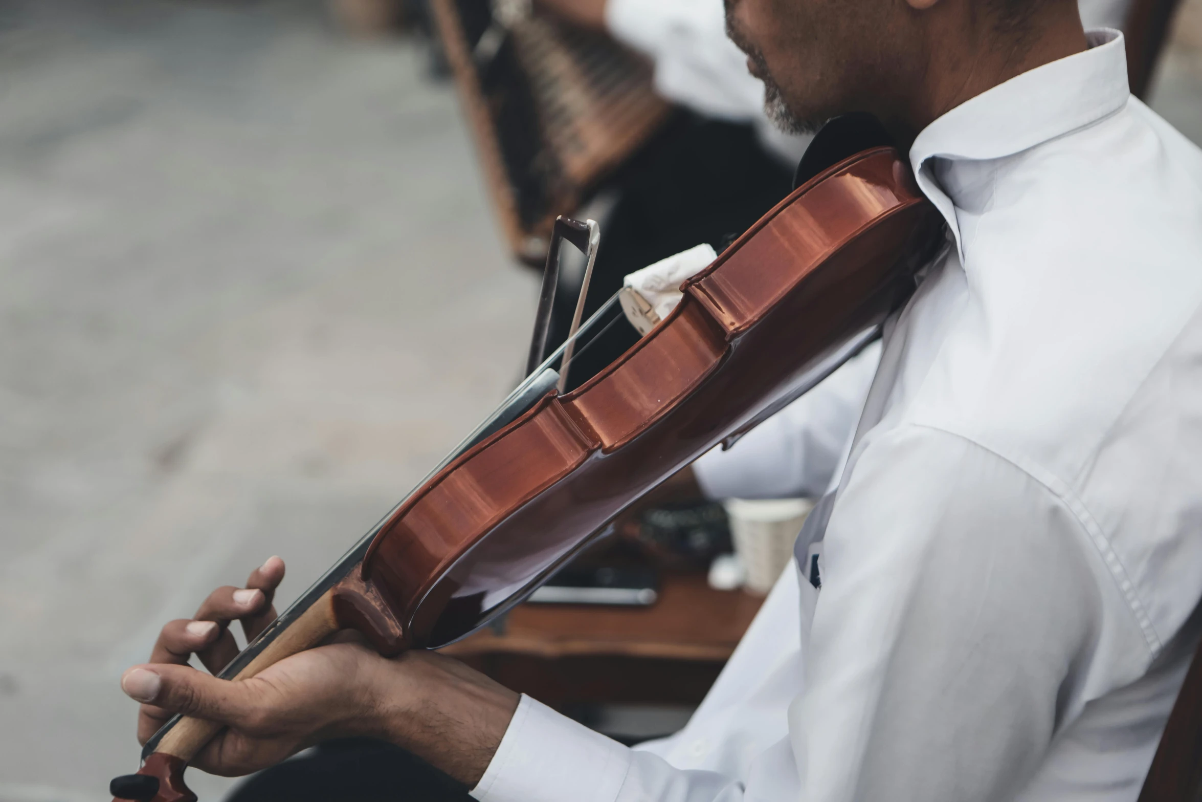 a man wearing a tie holding a violin case