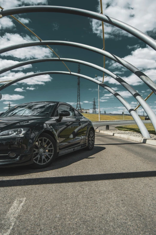 an all black sport car is parked on the side of the road