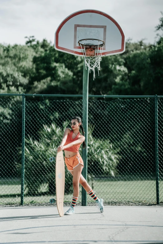 a person is playing basketball by a goal