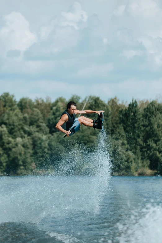 a man jumping over the water in the air