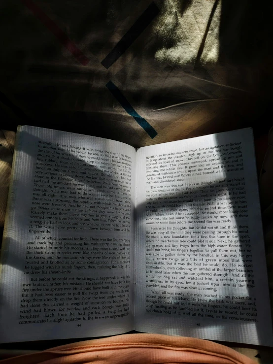 a open book on top of an orange cushion