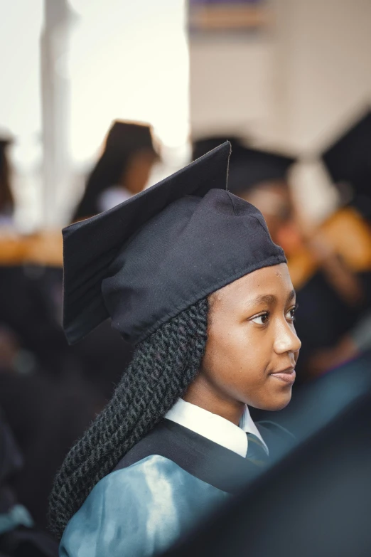 a woman in a cap and gown standing near others