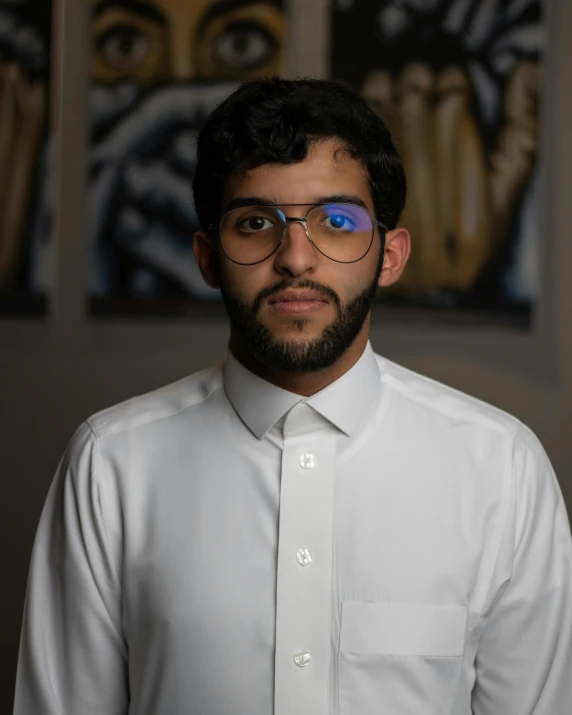 a man in a shirt and eye glasses