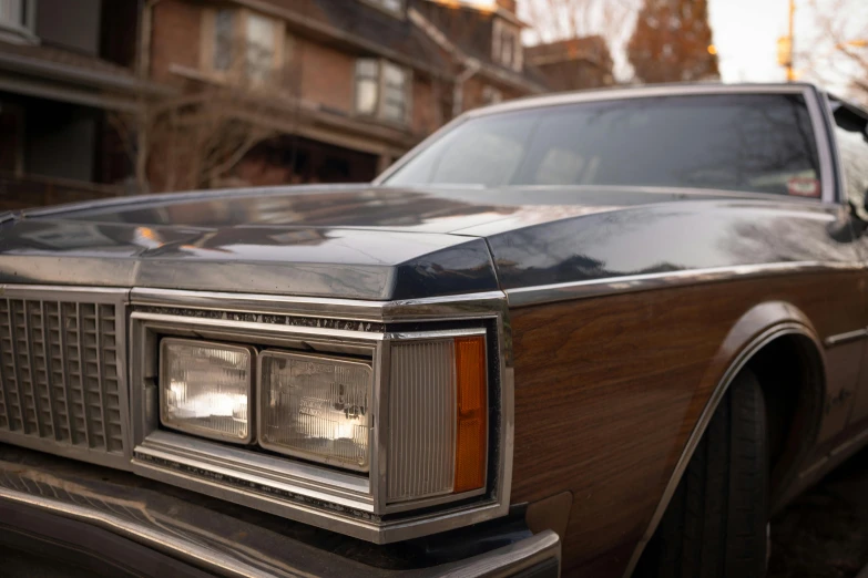 an old brown car is parked on a street