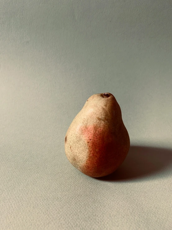 a small pear that is sitting on a table