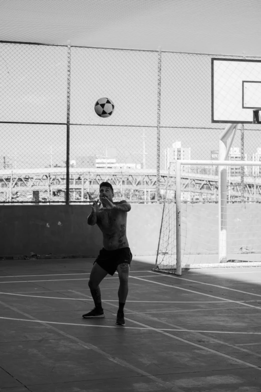 a man is kicking a ball around in a soccer field