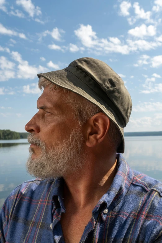 a man with a beard in the water wearing a hat