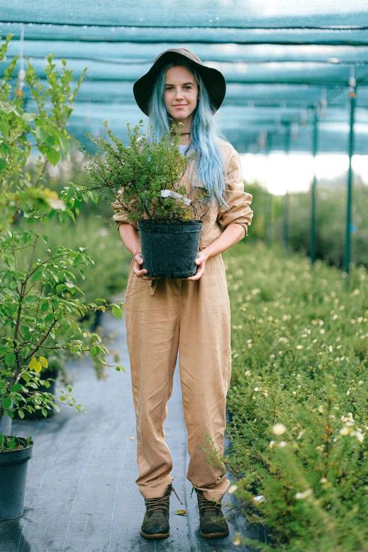 an image of a woman holding flowers in a greenhouse