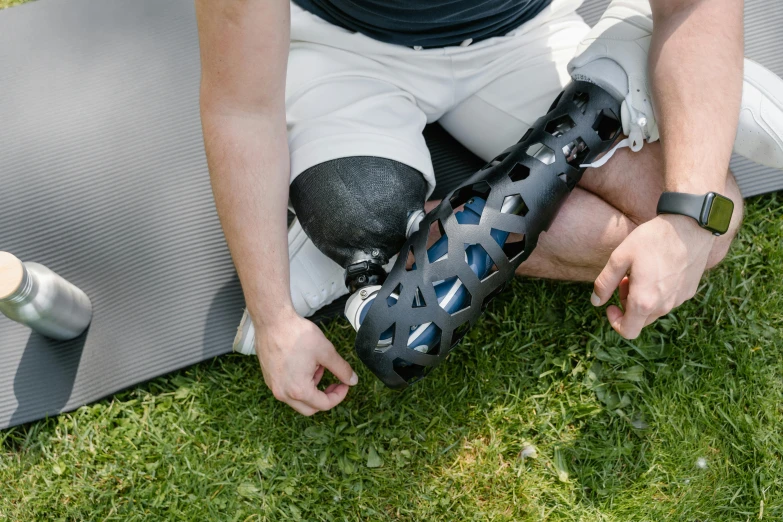 the legs of a player sitting in the grass