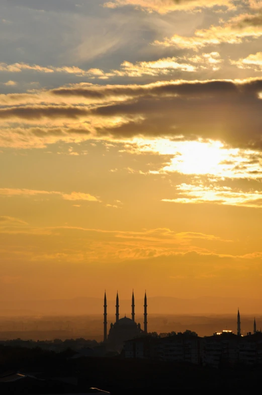 a sun setting over a city and tall building