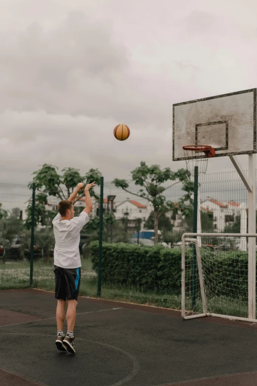 young man in basketball uniform throwing a ball