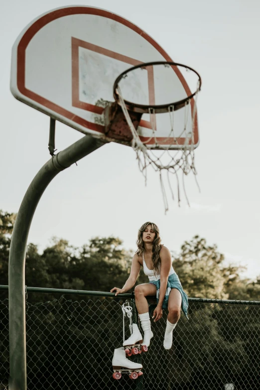 a young woman plays basketball on a wooden platform