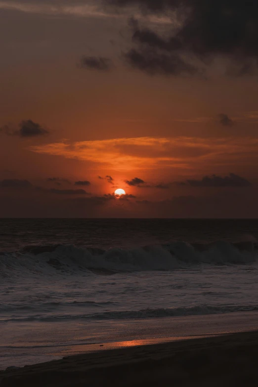 the sun is setting over the water as it sets in the distance