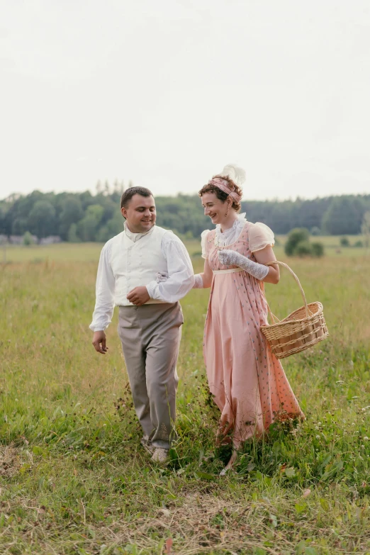 a man and a woman stand in a field